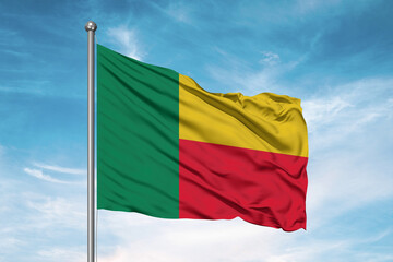 Benin national flag cloth fabric waving on beautiful sky Background.