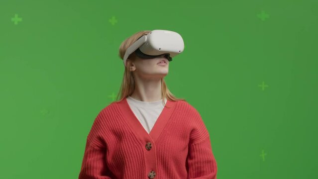 GREEN SCREEN CHROMA KEY Portrait of 20s Caucasian female using VR headset