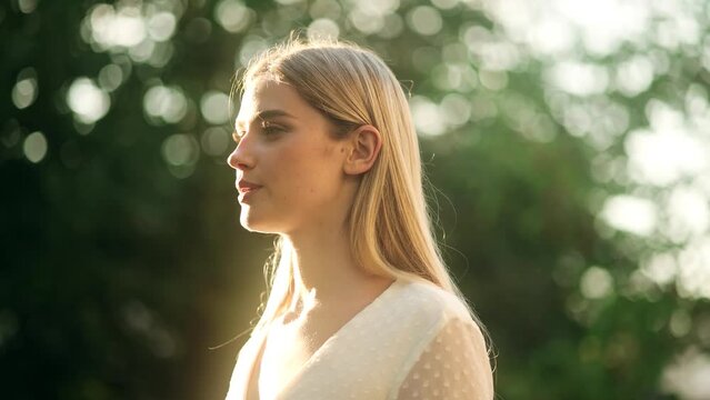 Portrait of Young Beautiful Woman with Long Blond Hair Exhaling Fresh Air, Taking Deep Breath and Reducing Stress