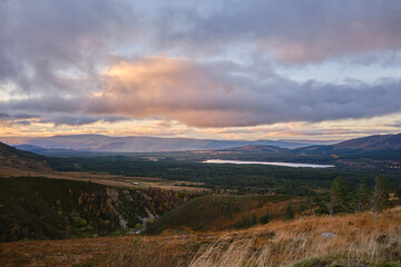 Beautiful view of a mountain river under overcast sky at sunset in Scotland