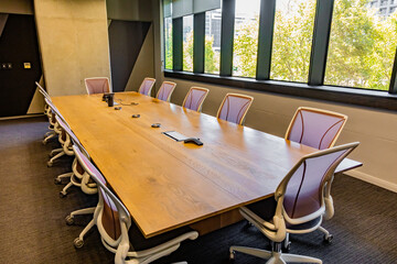 Empty boardroom table and chairs
