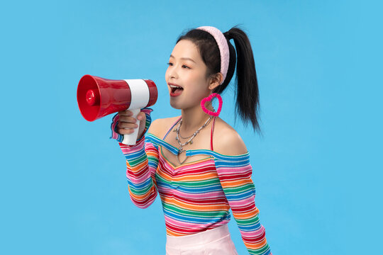 Stylish young girl holding megaphone