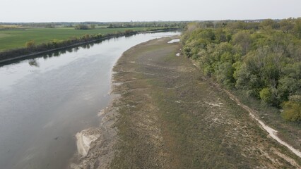 Fototapeta na wymiar Europe, Italy, Pavia Drought and aridity river - Po and Ticino , dry beach of sand and water shortage, water emergency in Lombardy - Drone view in Ponte della Becca - Climate change global warming