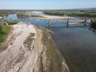 Europe, Italy, Pavia  Drought and aridity river - Po and Ticino , dry beach of sand and water shortage, water emergency in Lombardy - Drone view in Ponte della Becca - Climate change global warming