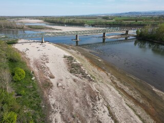 Europe, Italy, Pavia  Drought and aridity river - Po and Ticino , dry beach of sand and water shortage, water emergency in Lombardy - Drone view in Ponte della Becca - Climate change global warming