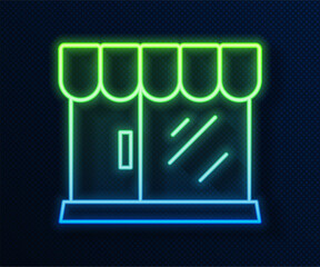 Glowing neon line Barbershop building icon isolated on blue background. Vector