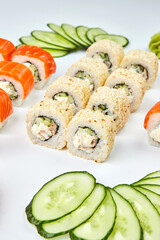 Traditional delicious fresh sushi set Philadelphia roll with salmon, smoked eel and cucumber isolated on white background. Sushi menu. Japanese asian food