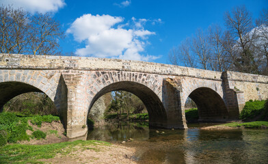 Fototapeta na wymiar Roman bridge on old royal road from Paris to Sens over Yerres river near Evry-Gregy-sur-Yerre and medieval town of Brie-Comte-Robert. Built in 17th-18th c. recalls architects name, Romains brothers