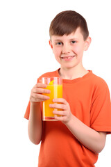 A cute cheerful boy in red tee shirt holding a glass of orange juice isolated on transparent background