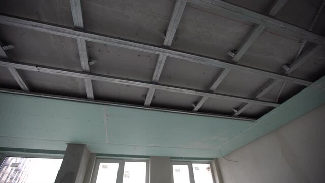Ceiling installation with expert technicians In the room that is in the construction process