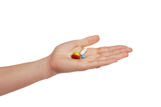 Colorful pills and tablets in the woman hand