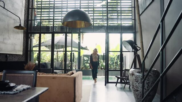 Young woman relaxing at home alone, single independent woman. Concept of real estate rent and sales, luxury dark interior.