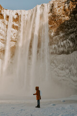 Young male exploring waterfall in Iceland
