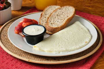 Closeup shot of a healthy breakfast with egg whites, slices of bread, and strawberries