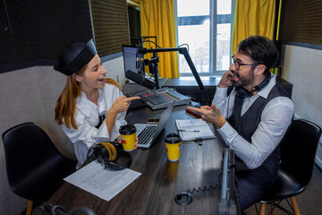 Radio dj talking to a guest in a radio studio