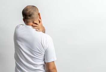 Man has problem with structural posture Neck and shoulder pain. Massaged his neck and shoulders for relief. reduce muscle tension.