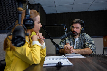 Fototapeta na wymiar Two people talking in the live broadcasting on the radio