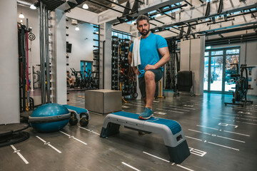 Man with towel in the gym after the workout