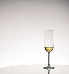 Glass cup of wine with reflection on a mirror surface