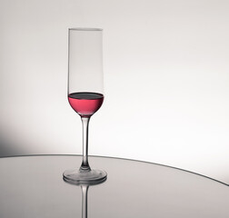 Drink in a glass cup with reflection on a mirror surface