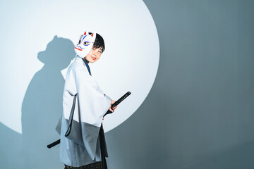 Child samurai wearing kimono. Japanese costume play.