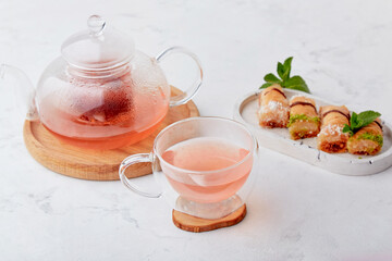 Healthy tea with cranberry and sea buckthorn. Turkish sweets baklava. Aesthetic tea time