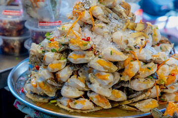 Staked of fish sauce-fermented sea crab in the try on seafood market stall, Food preservation with pickled fish sauce (in Thai: Poo talay dong nampla) Delicious street food in Thailand.