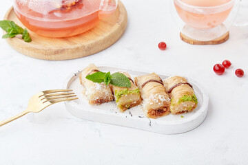 Natural organic tea with cranberry. Turkish sweets baklava. Aesthetic tea time, autumn breakfast