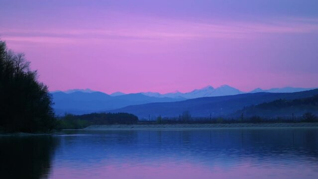 Beautiful view of a lake in the sunset with background of mountains.