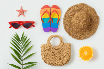 Tropical summer vacation concept with fashion bag; beach hat, flip flops and palm tree leaf  on white background. Top view from above - 591885964