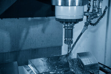 The CNC milling machine cutting the tire mold parts with oil coolant method .