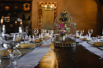 Closeup of the design of a wedding table with a decorative cage