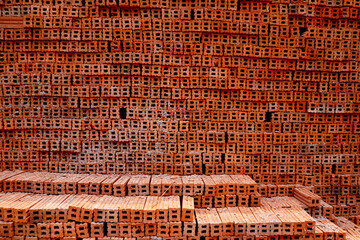 A pile of building materials stack of new red bricks for construction background 