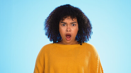 Surprised, face of black woman in studio, Shocked and wondering on blue background. Doubt, portrait...