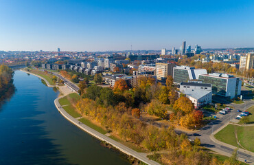Fototapeta premium Vilnius Cityscape with Autumn Trees, River Neris in Background. Lithuania