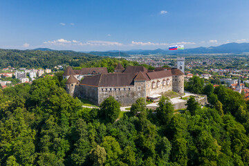 Obraz premium Ljubljana Castle and old town in Slovenia. Ljubljana is the largest city. It's known for its university population and green spaces, including expansive Tivoli Park. The curving Ljubljanica River