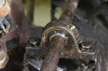 Ball bearing of water pump with dirty grease . Spherical roller bearing is dirty with grease stains .