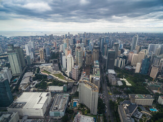 Fototapeta na wymiar Manila Cityscape, Makati City with Business Buildings and Cloudy Sky. Philippines. Skyscrapers in Background.