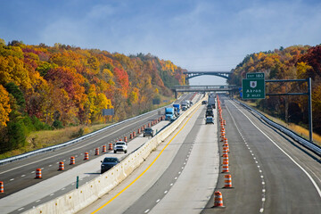 The Ohio Turnpike below a landmark overpass above the Cuyahoga Valley amid vivid autumn colors - obrazy, fototapety, plakaty