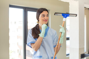 pretty young model smiling with a happy, confident expression with hand on chin. windows washer...