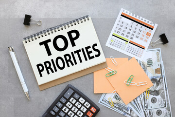 top priority . calculator calendar and gray background with text