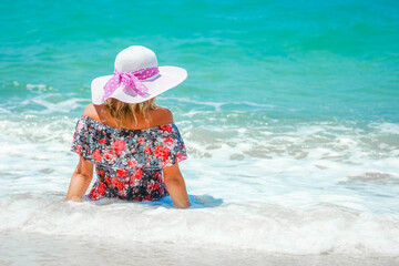 A Happy girl on the shore of the sea in travel vacation