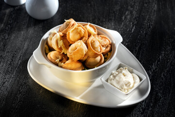 close up view of plate with dumplings on grey background.