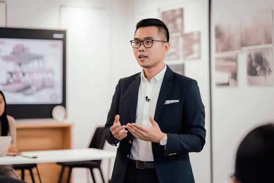 A fictional person. Charismatic Speaker Giving Business Presentation in Coworking Space, Southeast Asia