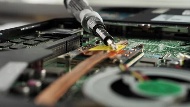 Electronic board of an old broken laptop. Rotating Dusty broken laptop in repair.