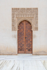 Islamic Moorish architecture style ancient wooden door in Alhambra, Granada, Andalusia, Spain.
