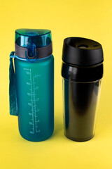 Reusable plastic drinkware on a yellow background.