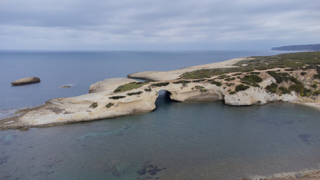aerial view of the rock of S'Archittu di Santa Caterina in the province of Oristano, Sardinia, Italy
