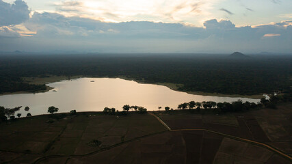 Aerial view of Lake and rainforest during sunset. National park in Sri Lanka.