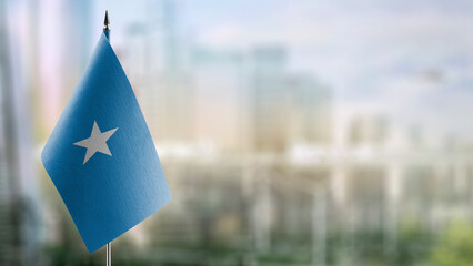 Small flags of the Somalia on an abstract blurry background